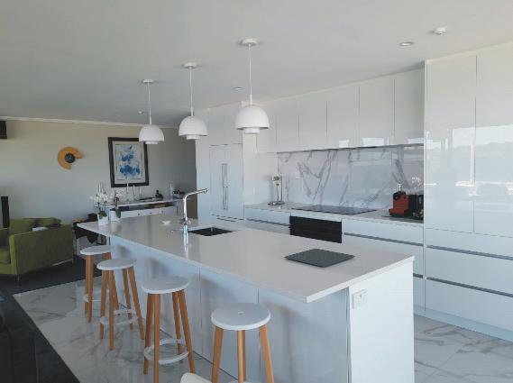 Bright white kitchen with breakfast bar and stools